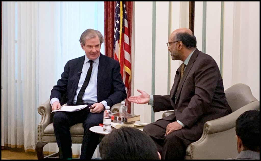 Two people in suits having a conversation