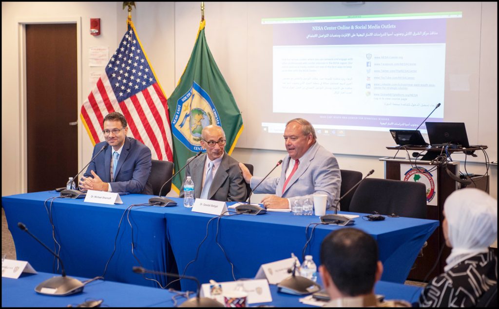 3 speakers at a table.