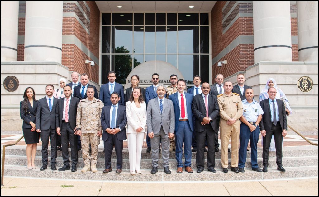 Group photograph of seminar participants on steps of building.