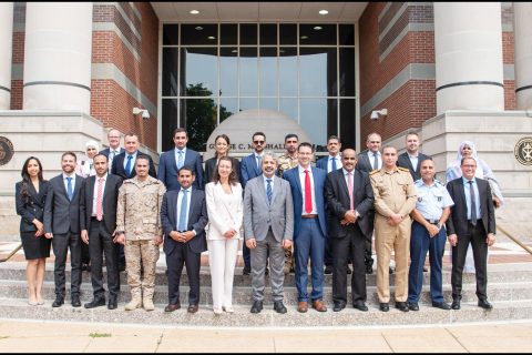 Group photograph of seminar participants on steps of building.