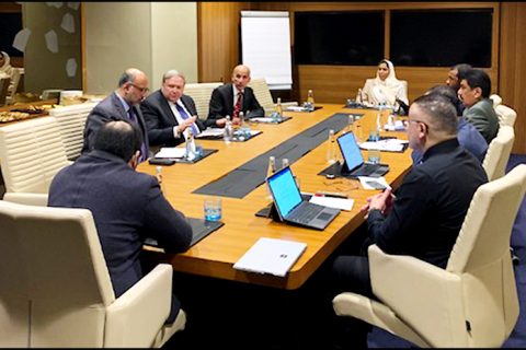 A group sitting around a table talking.